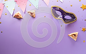 Happy Purim carnival decoration concept made from mask and sparkle star and hamantaschen cookies on pastel background. Happy