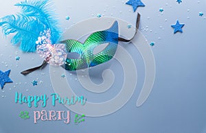 Happy Purim carnival decoration concept made from mask and sparkle star and hamantaschen cookies on pastel background. Happy