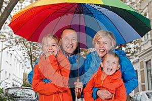 Happy rain family smile under umbrella