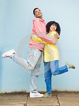 Happy, rain jacket and couple of friends hug with a smile and love for winter weather with happiness. Date, romance and