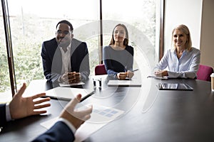 Happy recruiters listen candidate talk at work interview