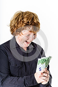 Happy red-haired boy with money