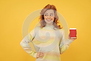 happy red haired woman drink coffee. take away beverage. cheerful girl drinking tea.