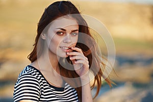 happy red-haired woman outdoors in the mountains smile model hairstyle