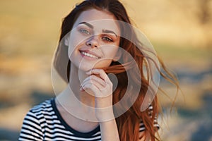 happy red-haired woman outdoors in the mountains smile model hairstyle