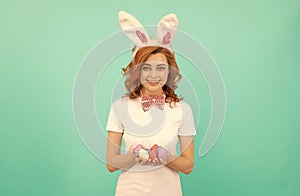 happy redhead girl in bunny rabbit ears with painted eggs, easter bunny