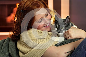 Happy redhead girl with cat