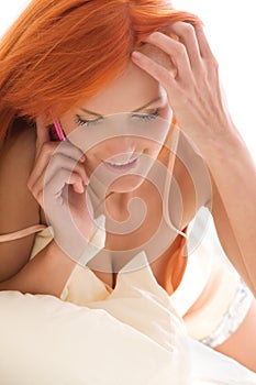 Happy redhead woman with cell phone