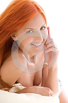 Happy redhead woman with cell phone