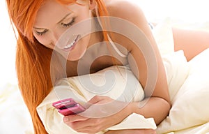 Happy redhead woman with cell phone