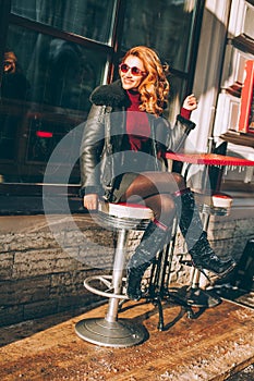 Happy Redhead Woman Laughing in Street Cafe