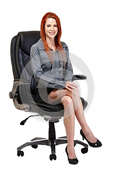 Happy redhead woman sitting on chair