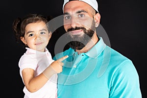 Happy relationship of handsome father and cute daughter embrace together against black background