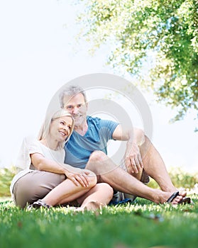 Happy, relax and senior couple in park for bonding, relationship and commitment outdoors on weekend. Portrait