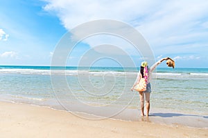 Happy and relax woman on the beach in summer day.