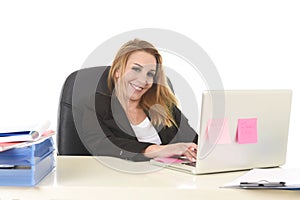 Happy relaxed 40s businesswoman smiling confident working at lap