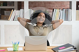 Happy relaxed african american female worker satisfied with finished work