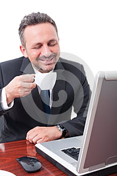 Happy and relaxed manager drinking espresso