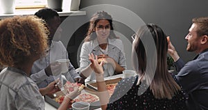 Happy relaxed multiracial business team people laughing eating takeaway pizza