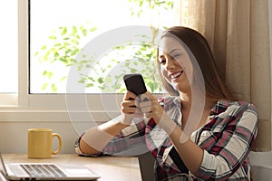 Happy relaxed woman texting on a mobile phone