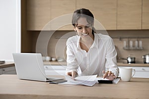 Happy renter, homeowner girl counting budget on calculator