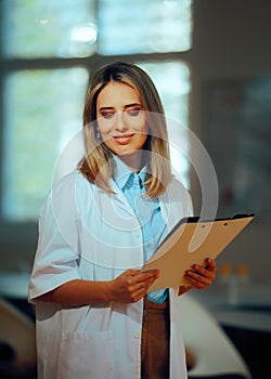 Happy Researcher Studying in the Laboratory Holding Clipboard