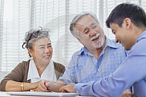 Happy retired Asian senior eldery couple consult with personal financial advisor or real estate agent. Retirement investment