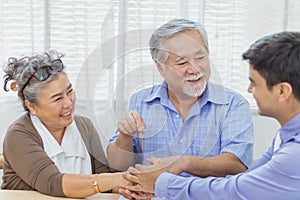 Happy retired Asian senior eldery couple hands shaking business deal and agreement with personal financial advisor or real estate