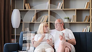 Happy retired couple drinking tea and spending time together. An elderly couple rests together