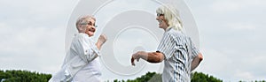 happy retired couple in glasses smiling