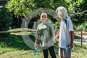 happy retired couple in sportswear with