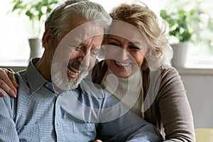 Happy retired family couple embracing spending time for pleasant conversation