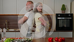 Happy retired family portrait at home kitchen Caucasian senior adult couple confident grandparents husband and wife