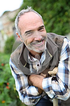 Happy retired man relaxing in garden