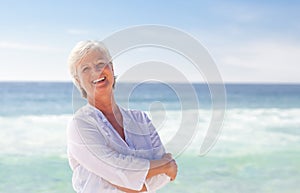 Happy retired woman on the beach