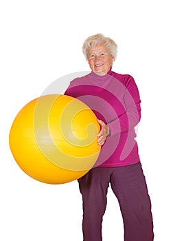 Happy retired woman holding gym ball