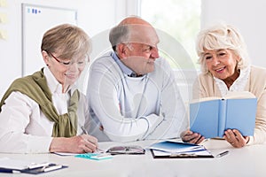 Happy retirees studying