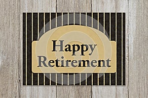 Happy Retirement message on a greeting card on weathered wood