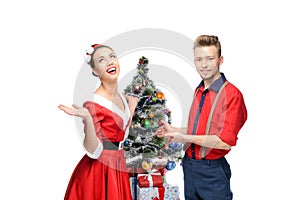 Happy retro couple near christmas tree