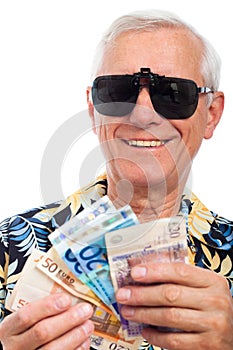 Happy rich elderly man with money