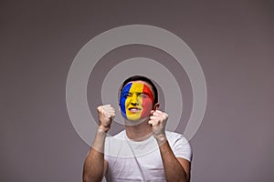 Happy Romanian football fan in game support of Romania national team