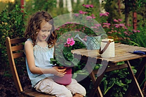 Happy romantic child girl dreaming in evening summer garden