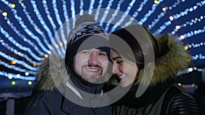 Happy romantic couple embracing at Valentines day in a evening city street. Slow motion.