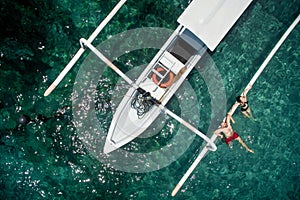 Happy romantic couple in love relax near a yacht in the sea while honeymoon