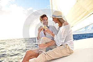 Happy romantic couple making toast on sailing cruise