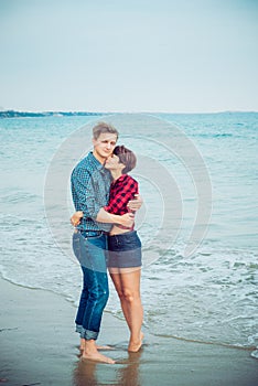 Happy romantic couple on the sea beach embracing each other. Concept of lovers happy moments on holiday, vacation. Boyfriend and g