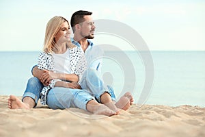 Happy romantic couple spending time together on beach