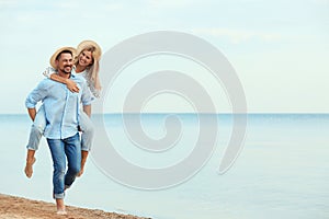 Happy romantic couple walking on beach