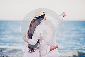 Happy Romantic Couples lover holding hands together walking on the beach