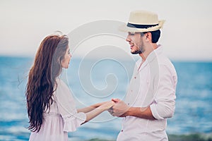 Happy Romantic Couples lover holding hands together walking on the beach